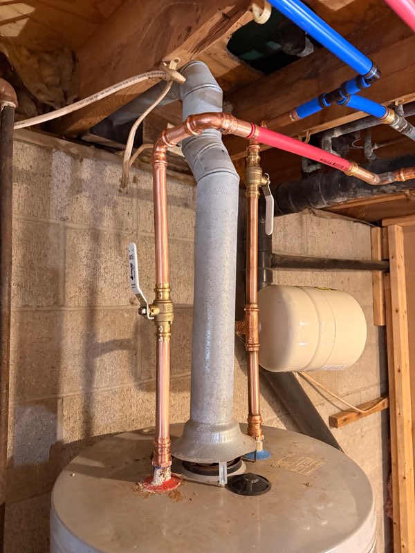 Basement repipe with new copper and PEX lines running to a water heater